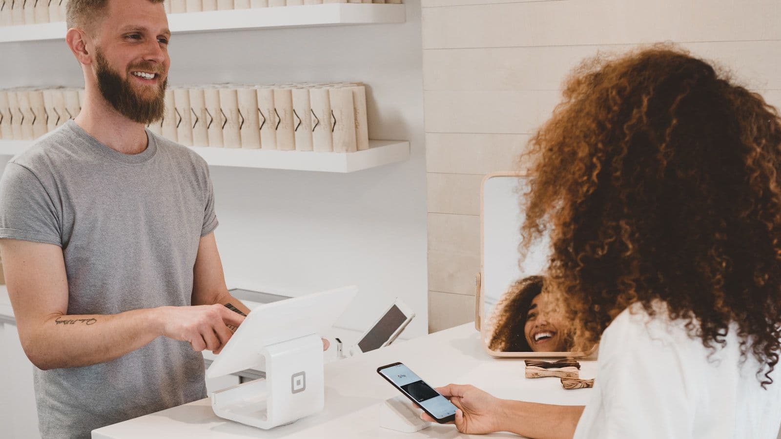 Customer making a contactless payment at a modern bank counter