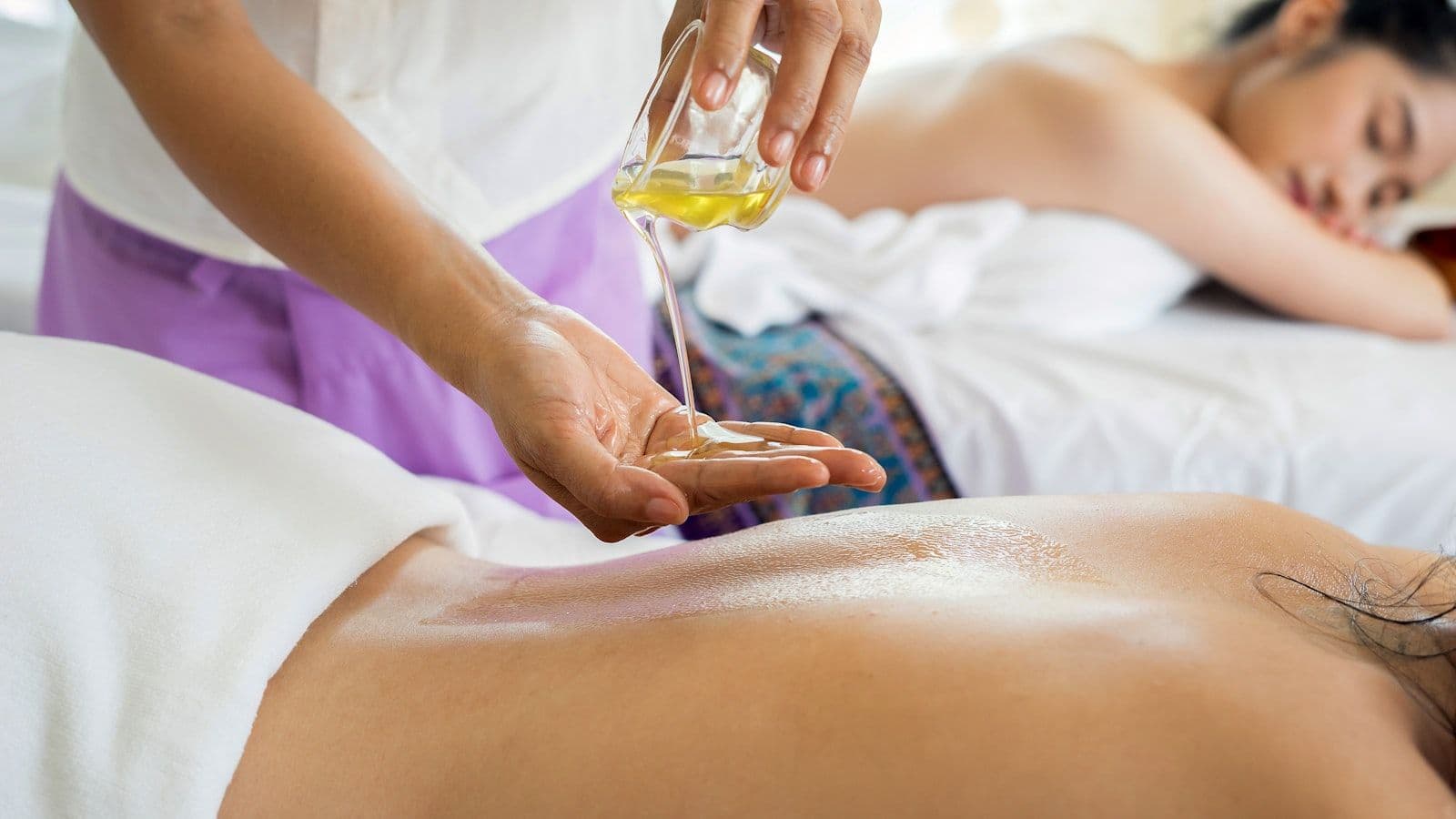 Relaxing spa oil massage treatment in serene environment